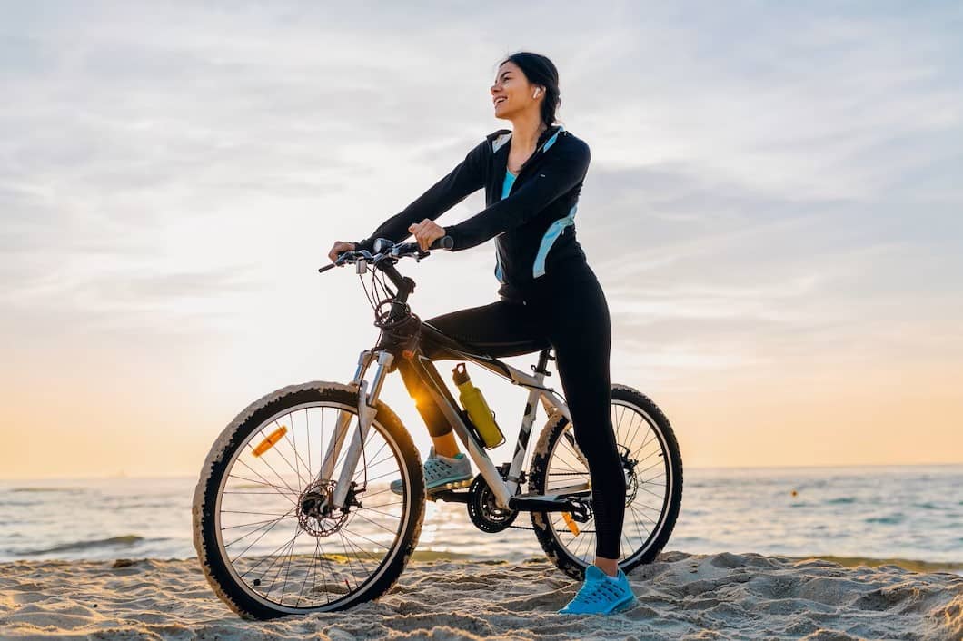 A lady enjoying the view sitting on a cycle